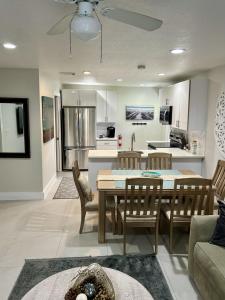 a kitchen and living room with a table and chairs at Casa Flamenco in West Palm Beach