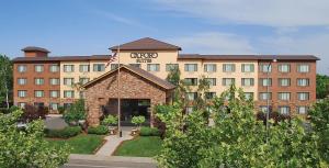 een hotel met een gebouw met een bord erop bij Oxford Suites Chico in Chico