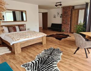 a bedroom with a bed and a zebra rug at Bran Mountain Living in Bran
