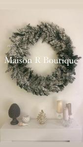 a wreath on a wall with a sign that reads malcolm r boutique at Maison R Boutique in Reggio di Calabria