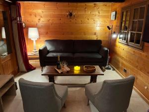a living room with a couch and a table at Chalet rénové 2-4 pers, terrasses, vue Mont Charvin - FR-1-505-187 in Crest-Voland +14 photos