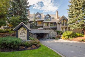 a large house with a sign in the front yard at Spacious Benchlands Chalet by Harmony Whistler in Whistler