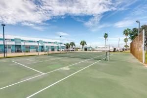 a tennis court in front of a building at Bayfront Texas Escape with Balcony and Pool Access! in Rockport