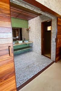 a bathroom with a large mirror in a room at Collina Beach in Amontada