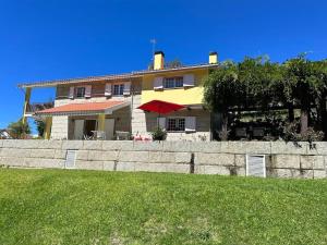 a large yellow house with a fence in front of it at Villa Avó Zizi in Alhões +50 photos