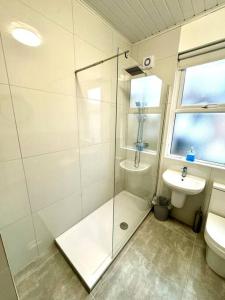 a bathroom with a shower and a toilet and a sink at Antrim Hideaway in Liverpool