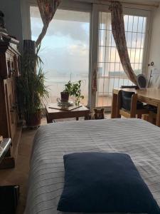 a bedroom with a bed and a large window at Baia dei Cesari in Bacoli