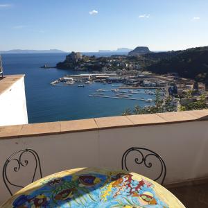 a table on a balcony with a view of a harbor at Baia dei Cesari in Bacoli