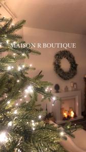 un árbol de Navidad en una sala de estar con chimenea en Maison R Boutique en Reggio Calabria