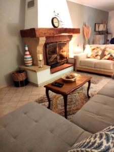 a living room with a couch and a fireplace at Welcome, Bienvenue, Chez Charly! in Nébian