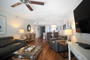 a living room with a couch and a ceiling fan at Fully Updated, Ground Floor, Poolside With Great Ocean View - Unit 49! in Cocoa Beach
