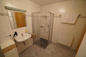 a bathroom with a shower and a sink at Oberstockachhof in Schwendau