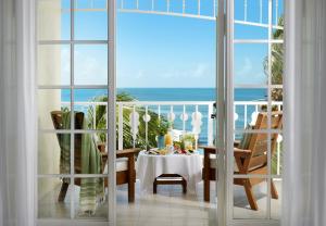 ein Esszimmer mit einem Tisch und Meerblick in der Unterkunft Ocean Key Resort & Spa, a Noble House Resort in Key West