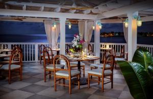 a dining room with a table with flowers on it at Ocean Key Resort & Spa, a Noble House Resort in Key West