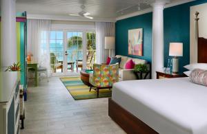 a bedroom with a bed and a living room at Ocean Key Resort & Spa, a Noble House Resort in Key West +33 photos