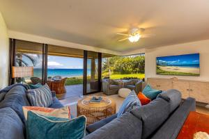 a living room with a couch and a table at Polo Beach Club 106 condo in Wailea