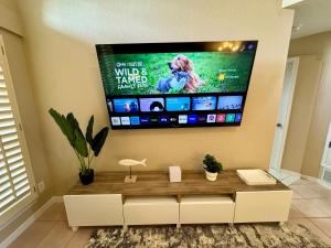 a living room with a flat screen tv on the wall at Peaceful West: 4BR Dusk Haven in El Paso