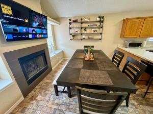 a dining room with a table and a fireplace at Peaceful West: 4BR Dusk Haven in El Paso