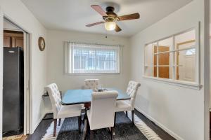 a dining room with a blue table and white chairs at Cozy 3BR Westland Retreat home in Westland
