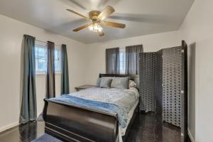 a bedroom with a bed with a ceiling fan at Cozy 3BR Westland Retreat home in Westland