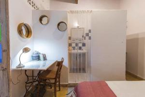 a bedroom with a desk and a bed and a table at MED APPARTEMENT in Essaouira