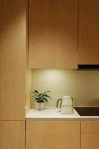 a kitchen counter with a toaster and a plant on it at Mr(s)STiL Design Apartments in Berlin