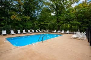 a swimming pool with lounge chairs at HTR Door County in Egg Harbor