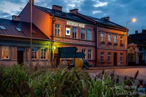 a building with a sign on the front of it at Apartamenty Galicja in Przemyśl