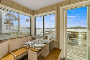 a dining room with a table and two windows at 154 Pinehurst Dr, Wareham in Wareham