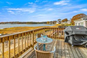 a table and chairs on a deck with a grill at 154 Pinehurst Dr, Wareham in Wareham