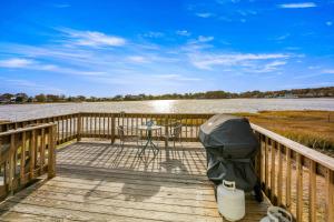a wooden deck with a table and a tablektopktop at 154 Pinehurst Dr, Wareham in Wareham