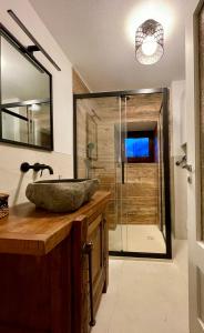a bathroom with a sink and a glass shower at maison la chapelle in Aosta