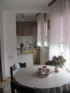 a table with two cups on it in a kitchen at Apartment SAFIR Sarajevo- Free parking in Sarajevo