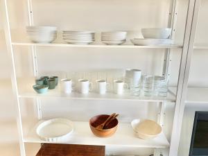 a white shelf with dishes and bowls on it at El Pisín de Avilés. Parking / WIFI in Avilés