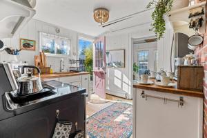 a kitchen with a sink and a stove top oven at Cottage Serenity Haven in Barnstable