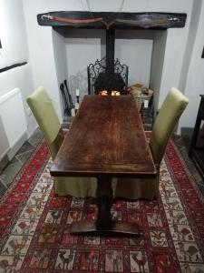 a dining room table with chairs and a fireplace at Michaelmas Cottage Upavon in Upavon +11 photos