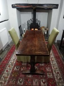 a dining room table with chairs and a fireplace at Michaelmas Cottage Upavon in Upavon
