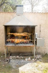 a grill with some food cooking in it at Guest Accommodation Slapovi Krke in Lozovac