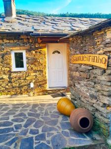 a stone house with a sign on the side of it at Casa do Salgueirinho in Casal do Rei