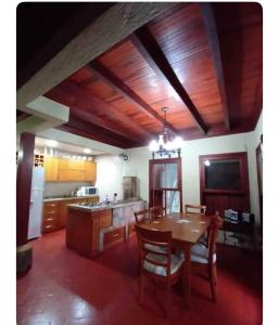 a kitchen with a table and a dining room at Casa de campo próximo a Gramado in Três Coroas