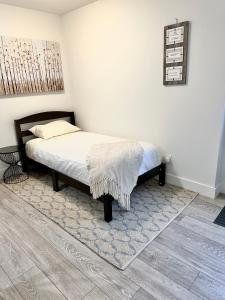 a bedroom with a bed with a blanket on it at Homelike & cozy suite in Langley