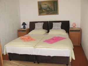 a bedroom with a bed with two towels on it at Apartman Safir in Sarajevo