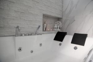 a white bath tub with two books on top of it at Royal Dreams in Caserta