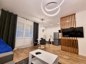 een woonkamer met een bank en een tafel bij City centar apartment - Sonje Marinkovic in Novi Sad