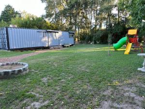 a park with a playground with a slide at Quinta las 4 M in Baradero +2 photos