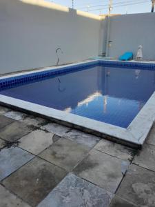 a swimming pool with blue water in a house at Casalagoana in Marechal Deodoro