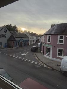 uma rua da cidade com casas e carros estacionados na rua em John & Mary's em Dromore