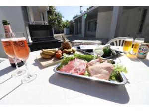 a table with a plate of food and a glass of beer at Shiraho Villa - Vacation STAY 20487v in Shiraho