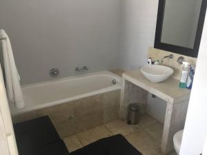 a bathroom with a sink and a bath tub and a sink at Breede View in Kontiki +36 photos