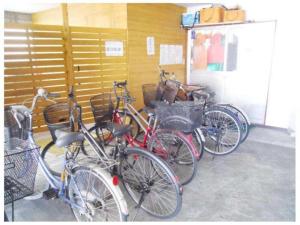 a group of bikes parked next to a garage at Minshuku Suzu - Vacation STAY 25825v in Shimanto